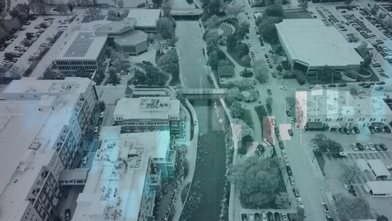 Aerial View of Downtown Naperville Showing Various Buildings, Streets, and A River, Highlighting Urban Development