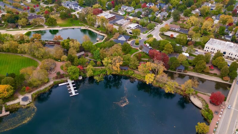 Aerial View of Naperville Showcasing a Vibrant Community with Lush Green Spaces, a Large Blue Lake, and Residential Areas During Autumn