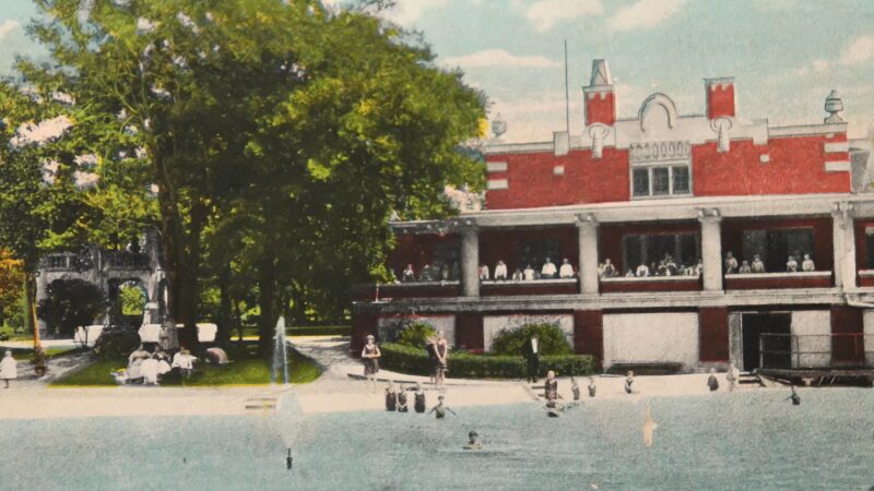 Historical Postcard Depicting a Lively Day at A Park in Peoria, Illinois, with People Enjoying the Waterfront and A Grand Pavilion in The Background