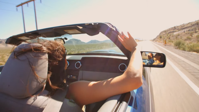 Couple Enjoying a Sunny Road Trip on Route 66 with The Top Down, Cruising Through Desert Landscapes